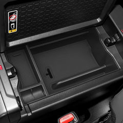 Non-slip mats keep small items from sliding in the console tray