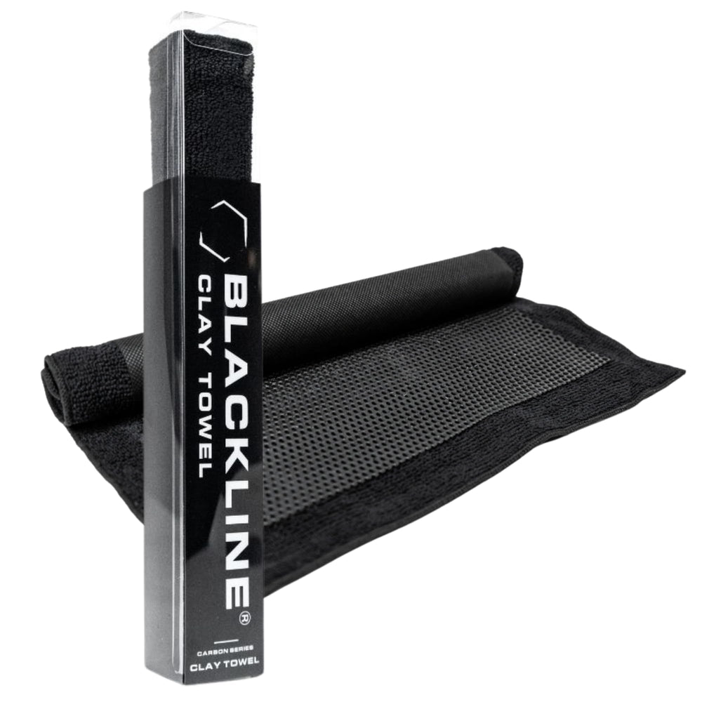 Blackline Clay Towel polymer layer close-up lifting tar from paint for surface decontamination.