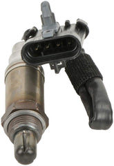 Bosch 15703 oxygen sensor in engine bay for precise exhaust monitoring.