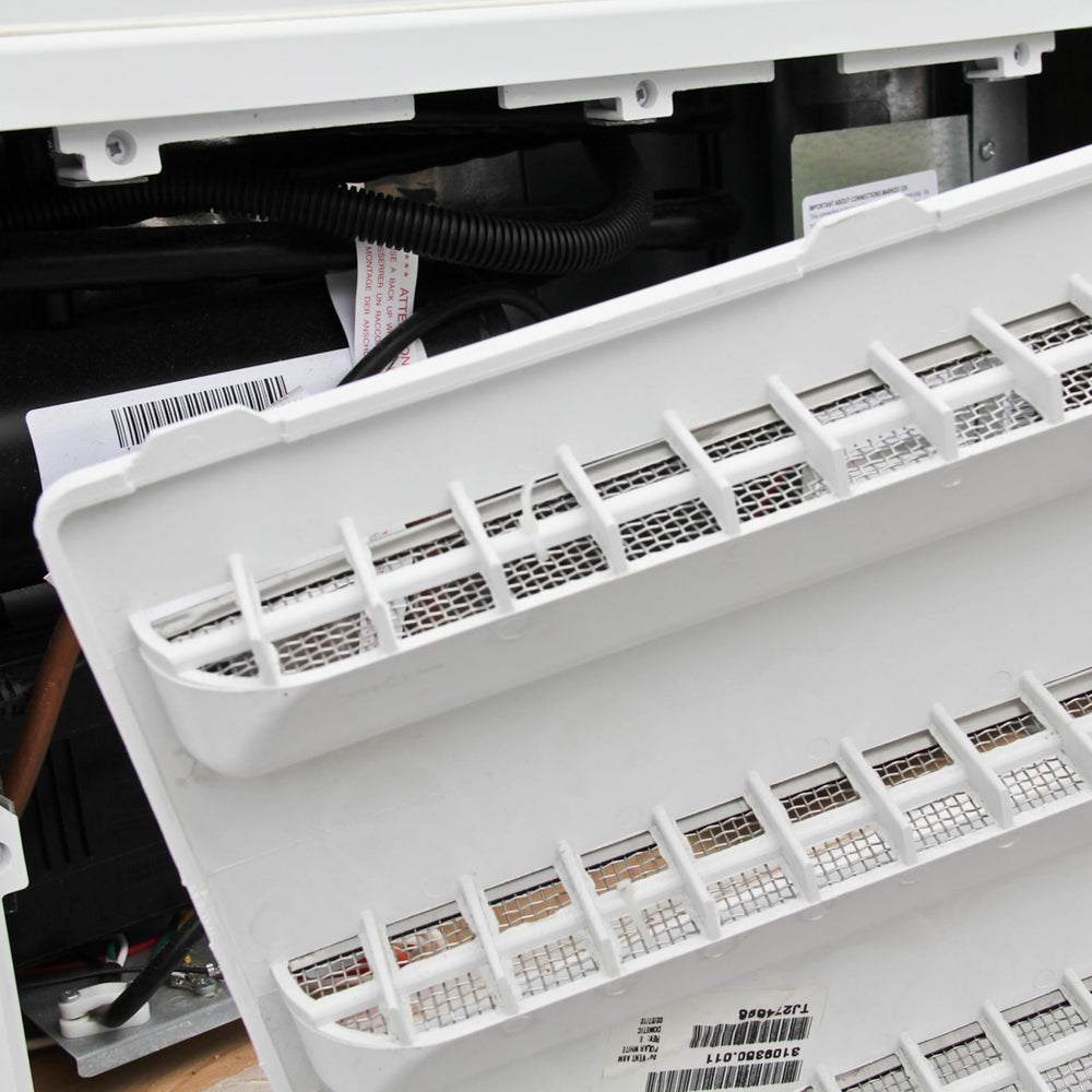 Close-up of screen mesh filtering insects around vent opening.