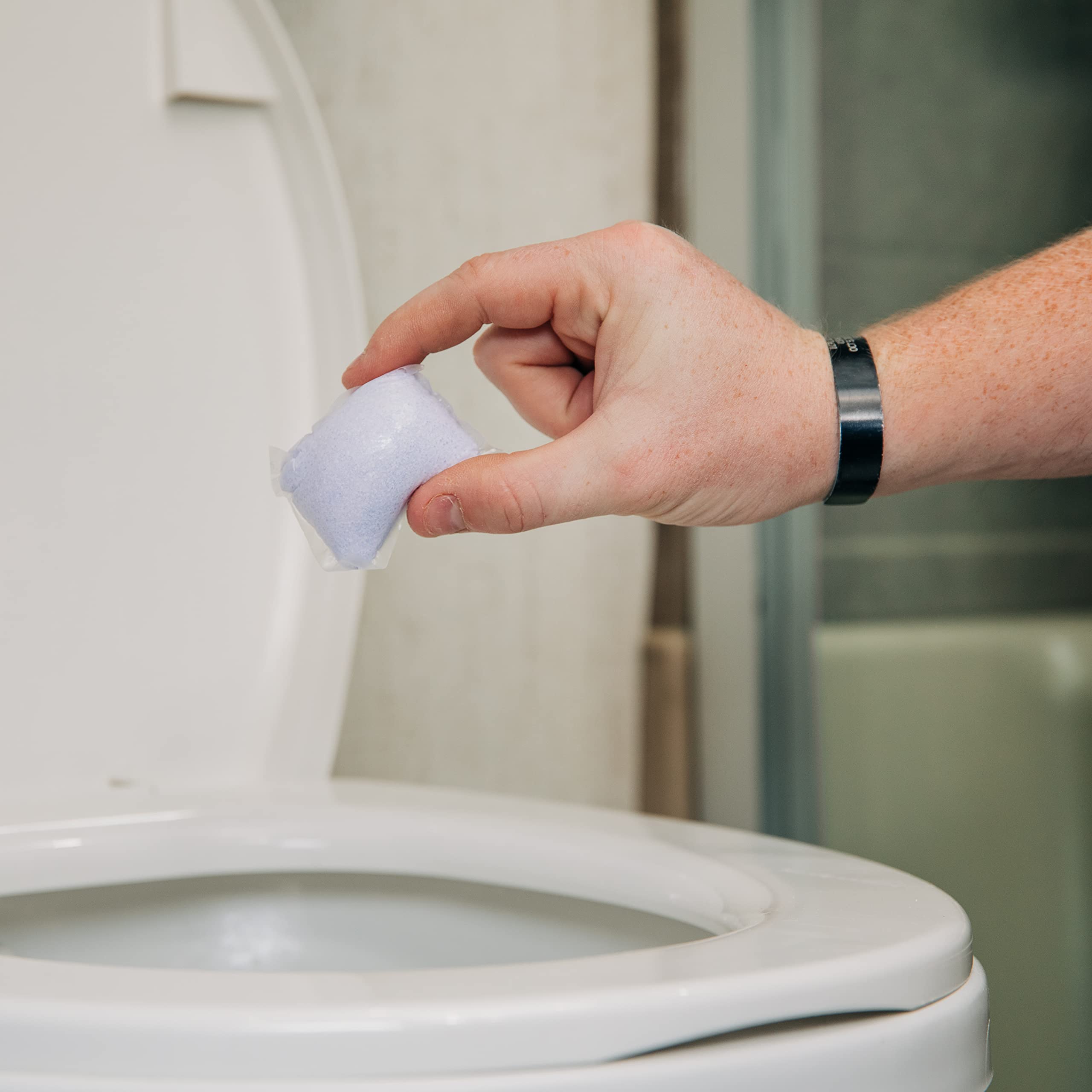 Close-up of Lavender Drop-In being placed in an RV toilet tank for odor control.