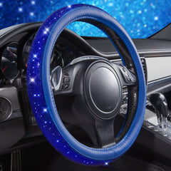 Close-up of CAR PASS rhinestones glittering on the steering wheel cover.