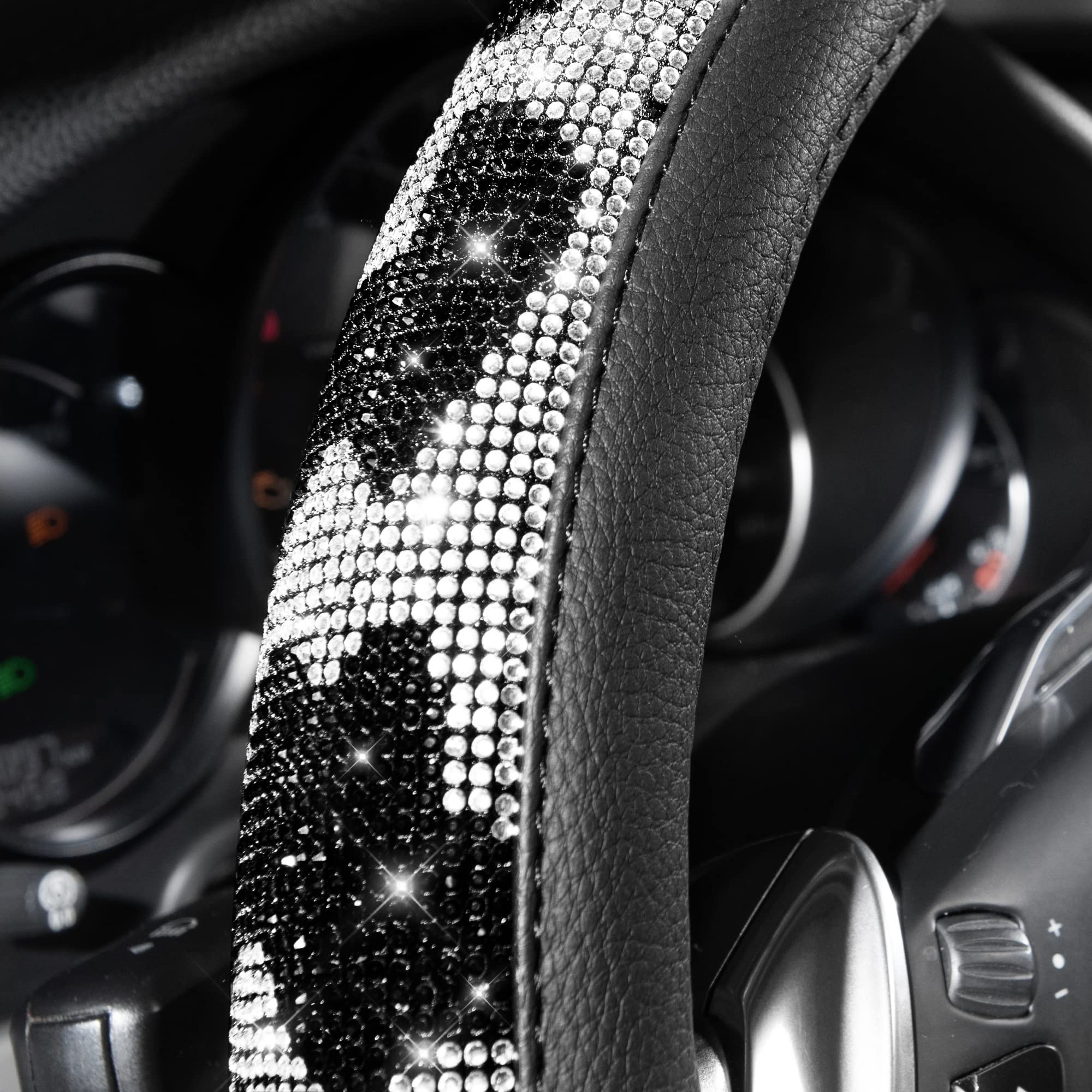 Close-up of luxury cow-print rhinestones on CAR PASS steering wheel cover.