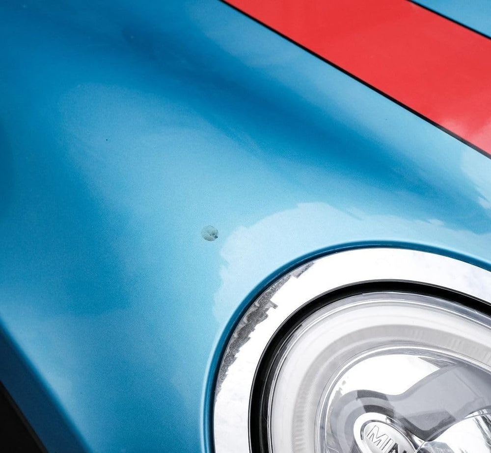 Professional detailer using TarX on a car surface