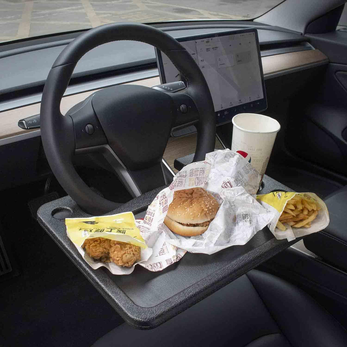 CarQiWireless steering wheel desk on Tesla Model 3 closeup shows sturdy surface for meals