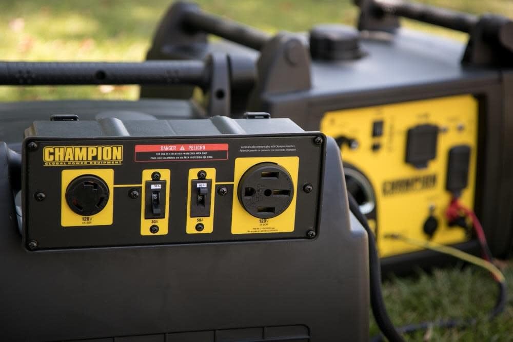 Two Champion inverters linked for expanded power in RV and camping setups.