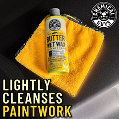 Chemical Guys Butter Wet Wax applied to car finish enhances gloss and depth.