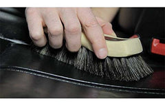 Horsehair brush reaches seams for deep leather cleaning with Chemical Guys.