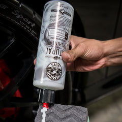 Applying Natural Shine with a pad for a clean, dry-touch finish.