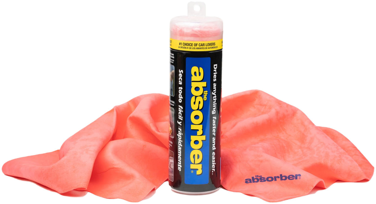 CleanTools the absorber large red drying cloth covering a car panel for fast, scratch-free drying.