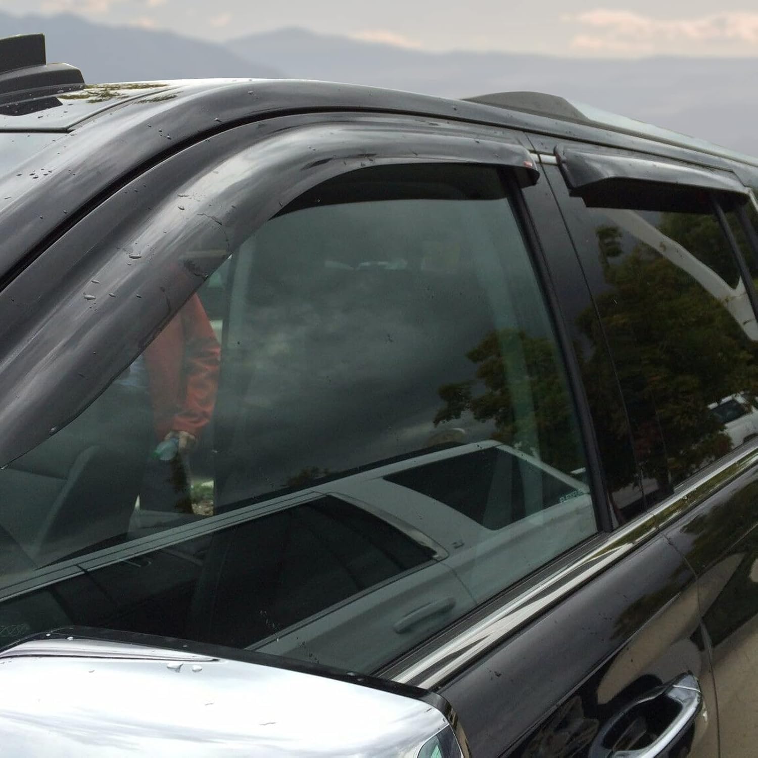 Cxdar window rain guard for Sierra 1500 Crew Cab enables ventilation in light showers.