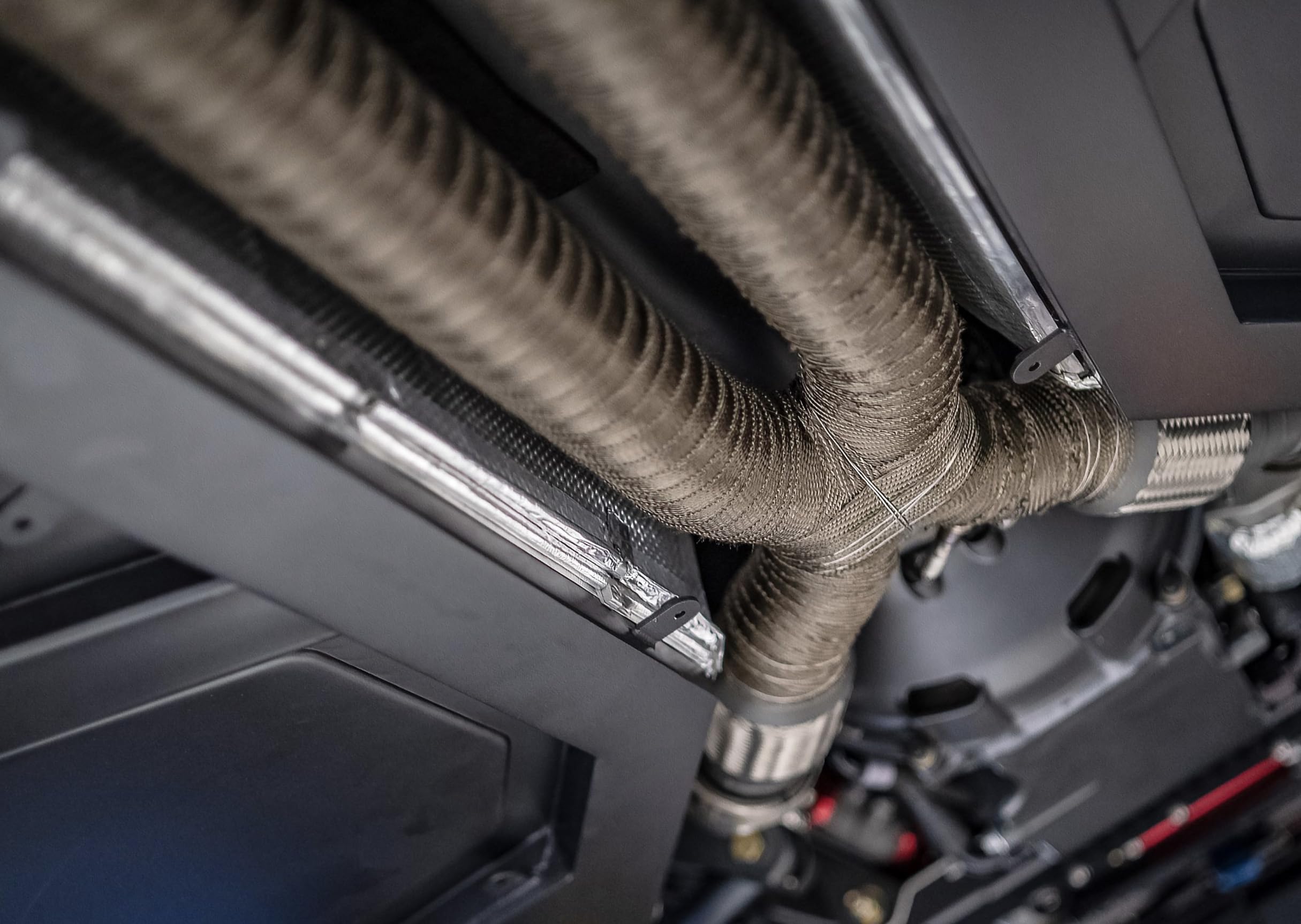Design Engineering Titanium Exhaust Wrap provides durable coverage resisting chemicals and vibration.
