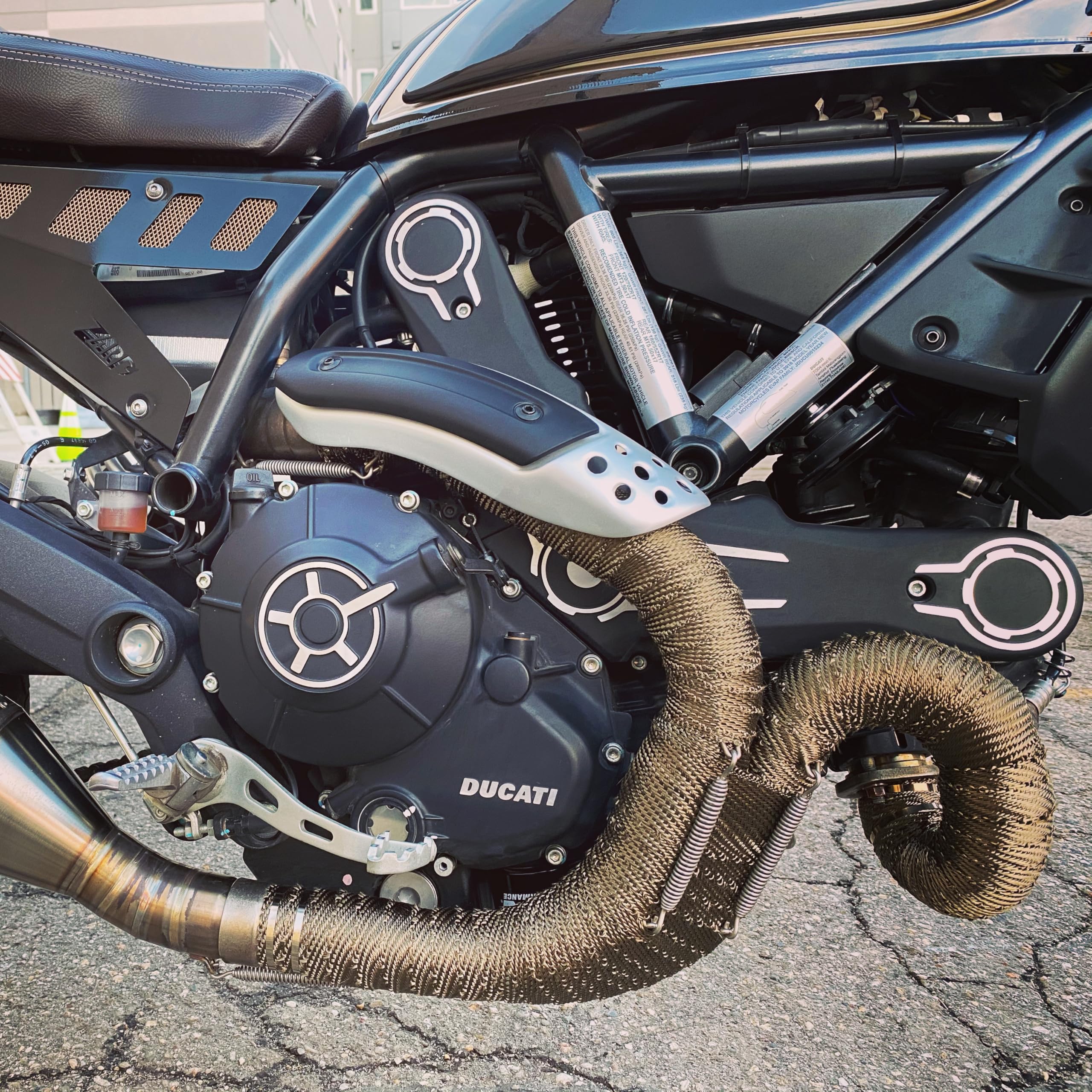 Design Engineering Titanium Exhaust Wrap installed on headers demonstrates easy curved fit.