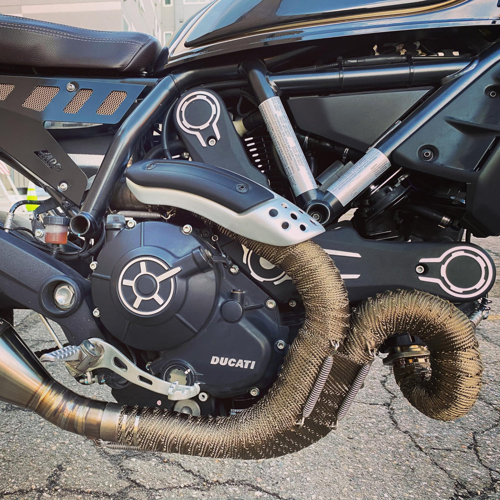 Design Engineering Titanium Exhaust Wrap installed on headers demonstrates easy curved fit.