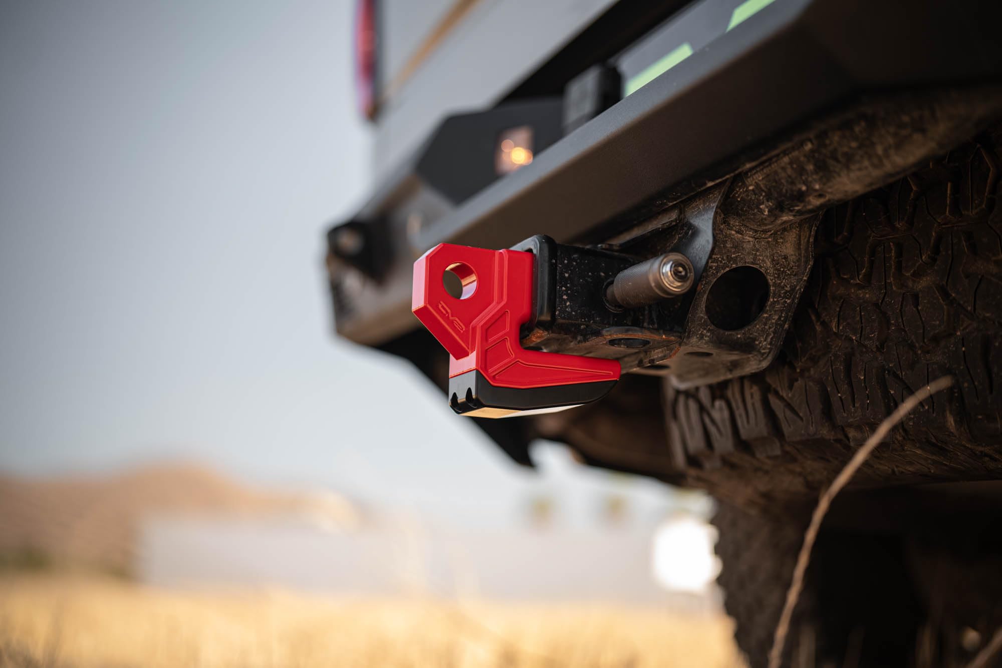 DV8 Offroad Xtract hitch skid plate features integrated 1-inch D-ring recovery point