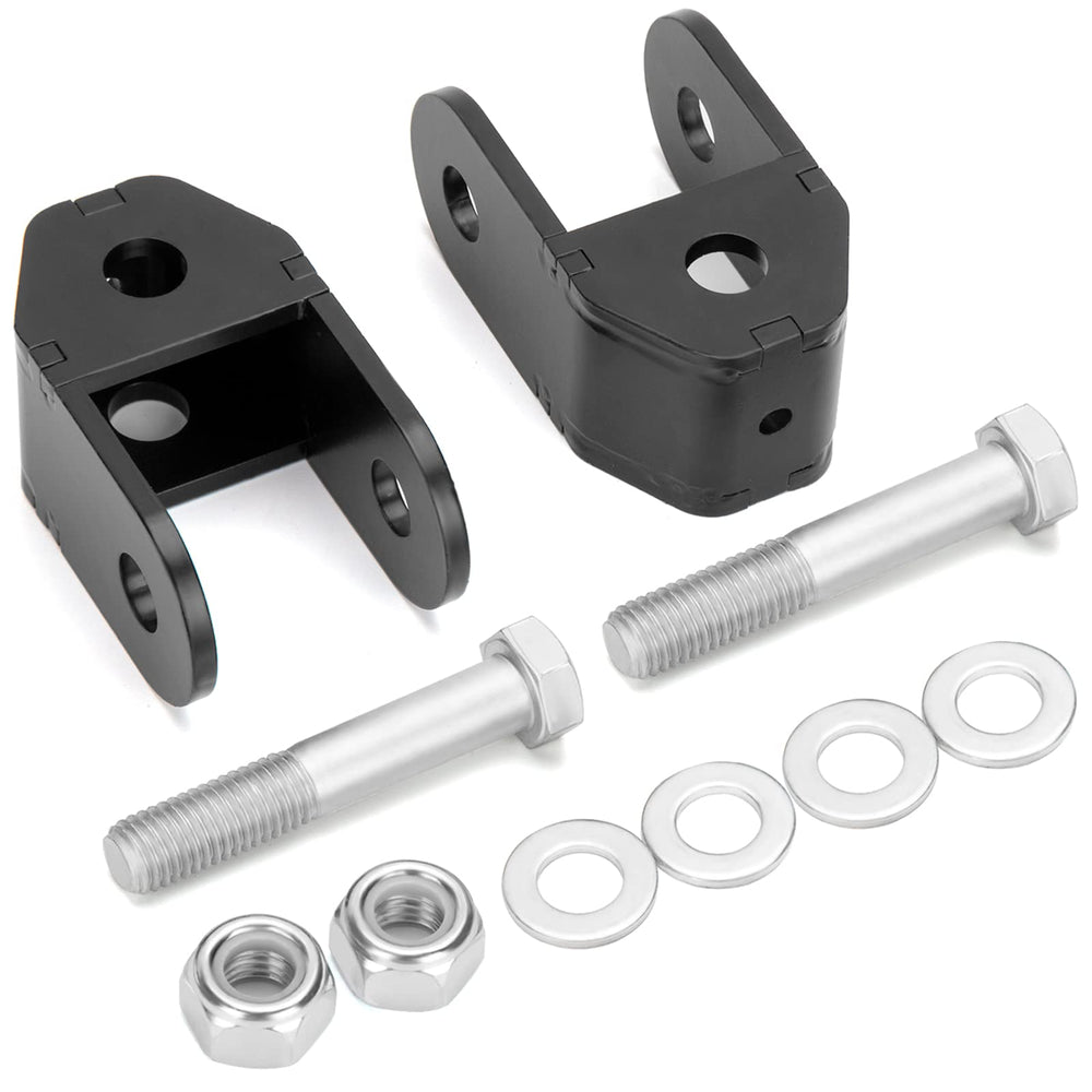 Dynofit rear shock extenders installed on a Silverado 1500 to improve suspension compatibility.