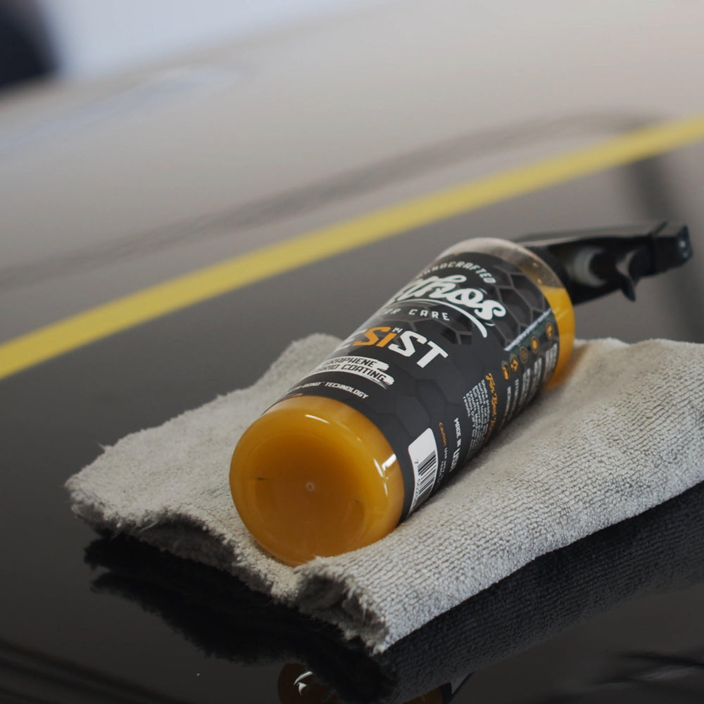 Ethos Resist graphene spray shows a glossy finish on a car panel