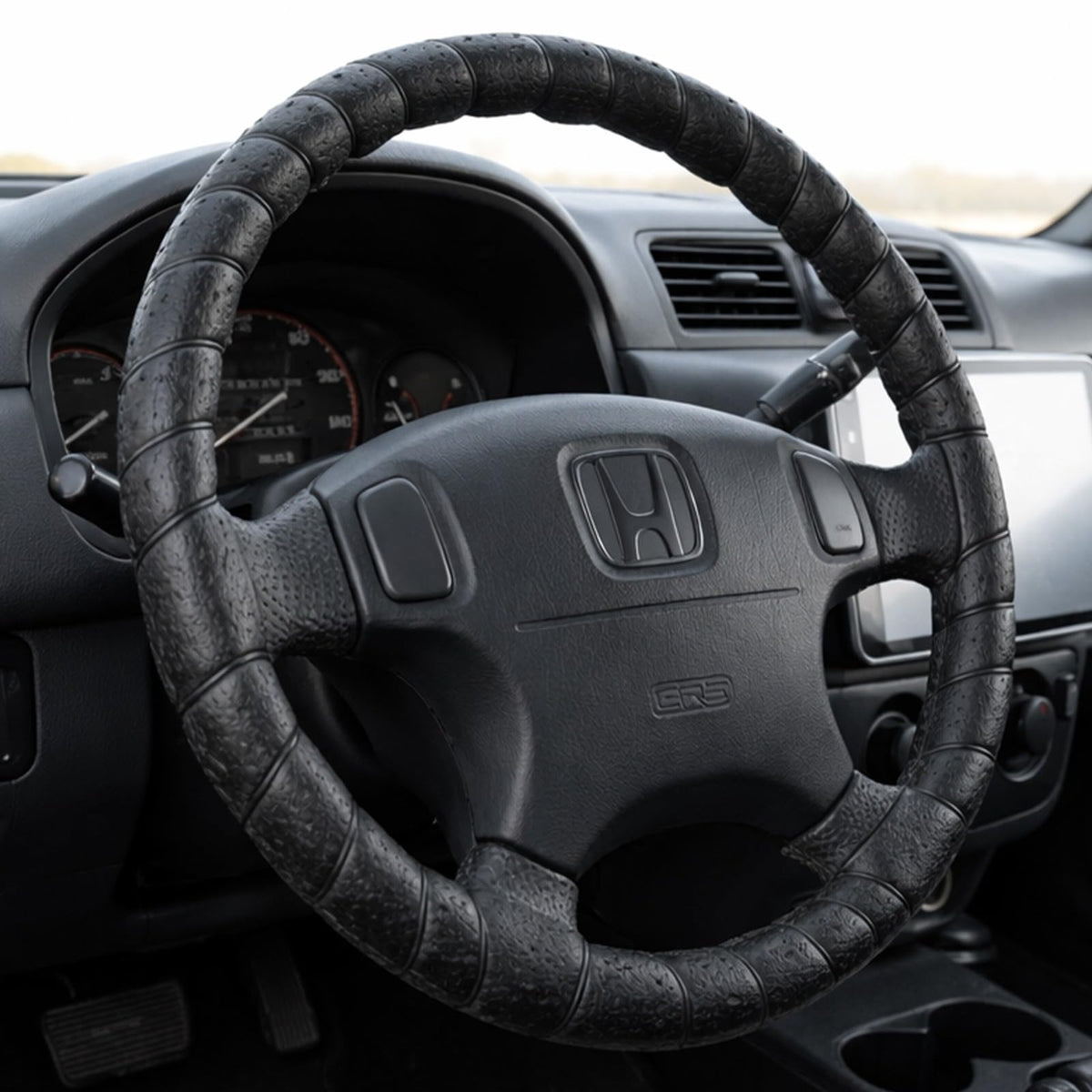 FINOO black lace-on steering wheel cover with universal 14-15 inch fit and secure lace-up design.