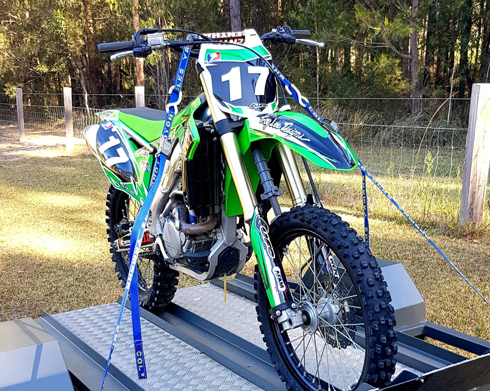 Fork-King dirt-bike fork protector is in use, shielding forks during loading.