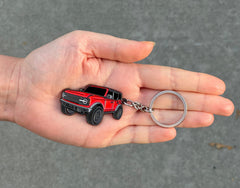 Four Wheel Beast Bronco keychain side detail highlighting raised metal accents.
