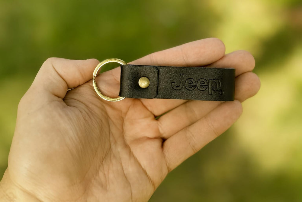 FOUR WHEEL BEAST Jeep keychain featuring the Jeep logo for official branding