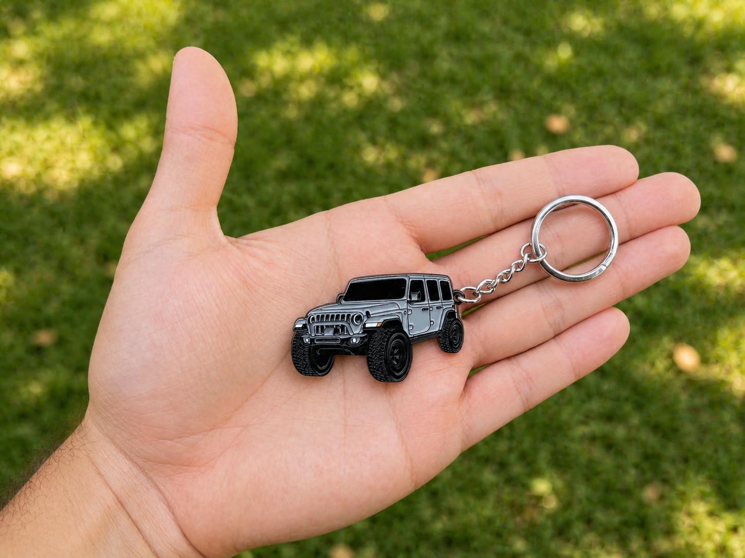 Four Wheel Beast keychain close-up highlighting raised metal enamel design and durability.