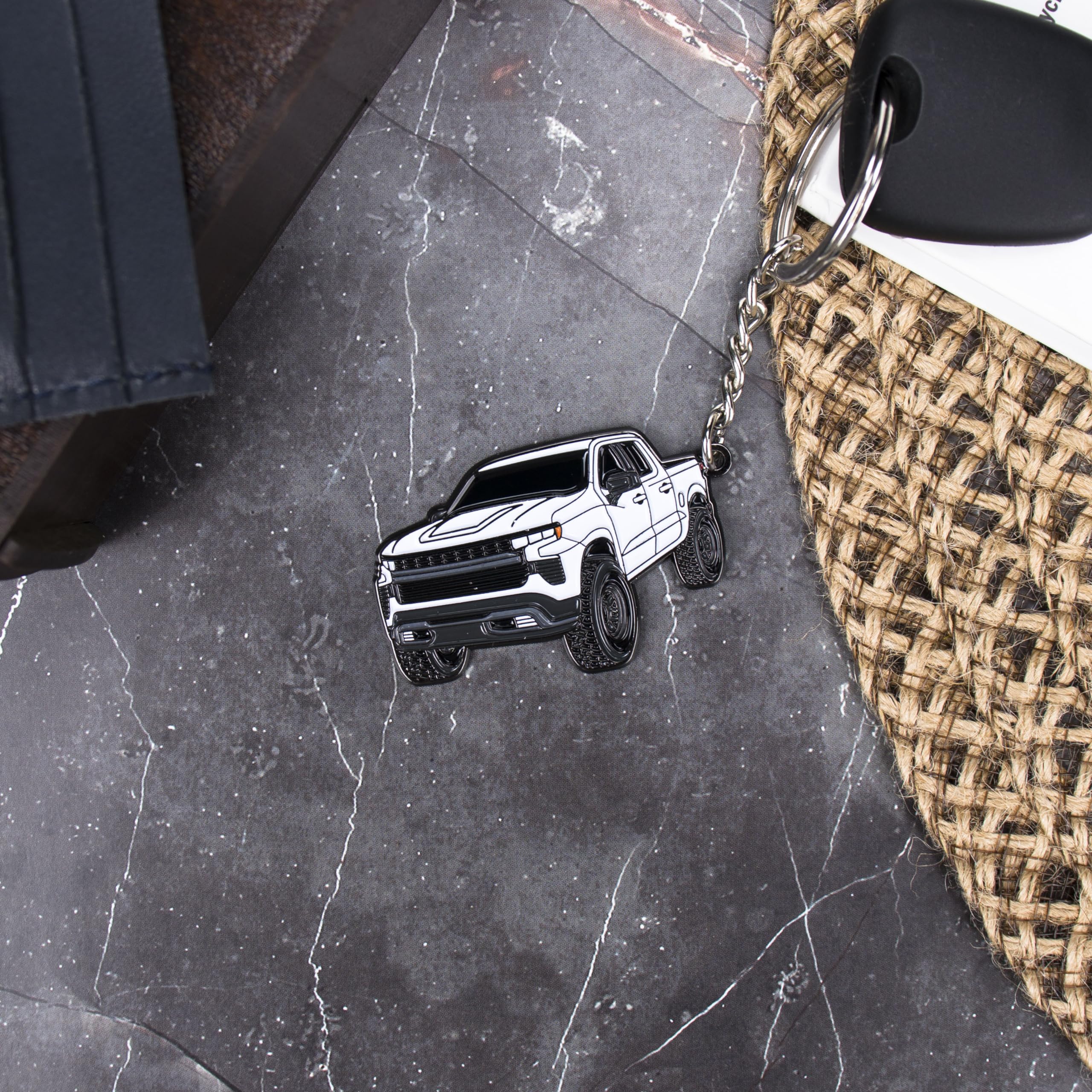 Four Wheel Beast white closeup enamel detail, raised design and premium feel.