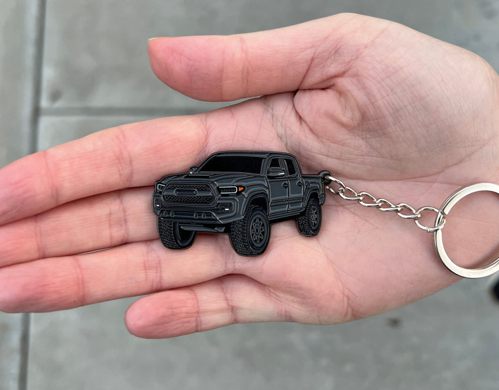Lightweight metal enamel keychain by Four Wheel Beast, easy to carry daily.