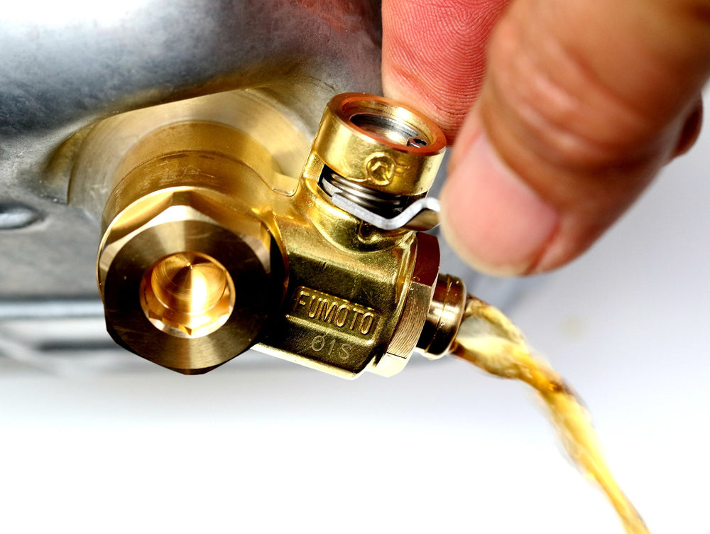 Professional shop uses Fumoto F103SX for efficient oil changes.