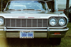 Generic aluminum license frame side profile emphasizes slim border that avoids plate obstruction.