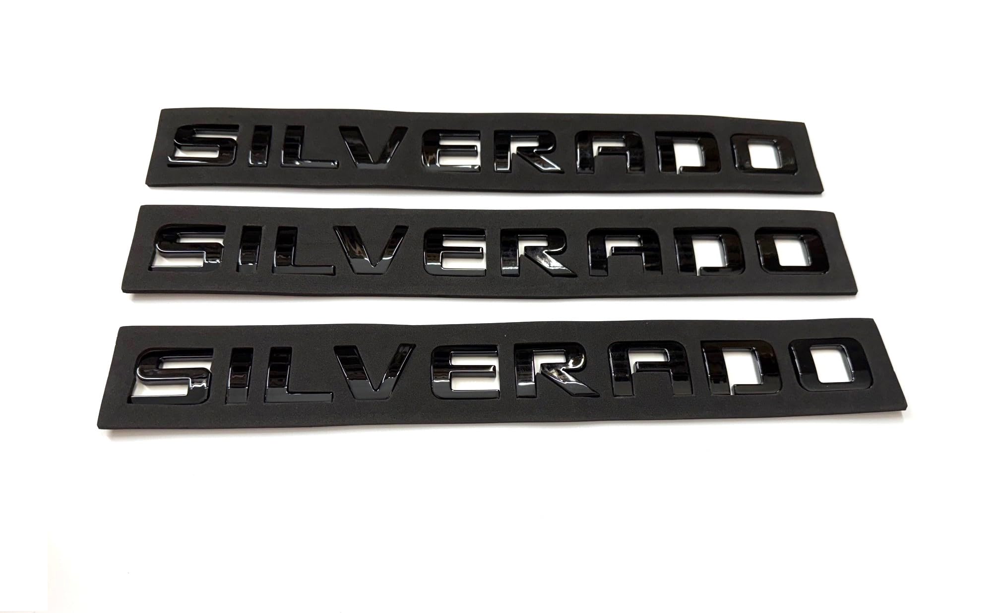 Generic black finish badge emblems close-up, bold exterior detail