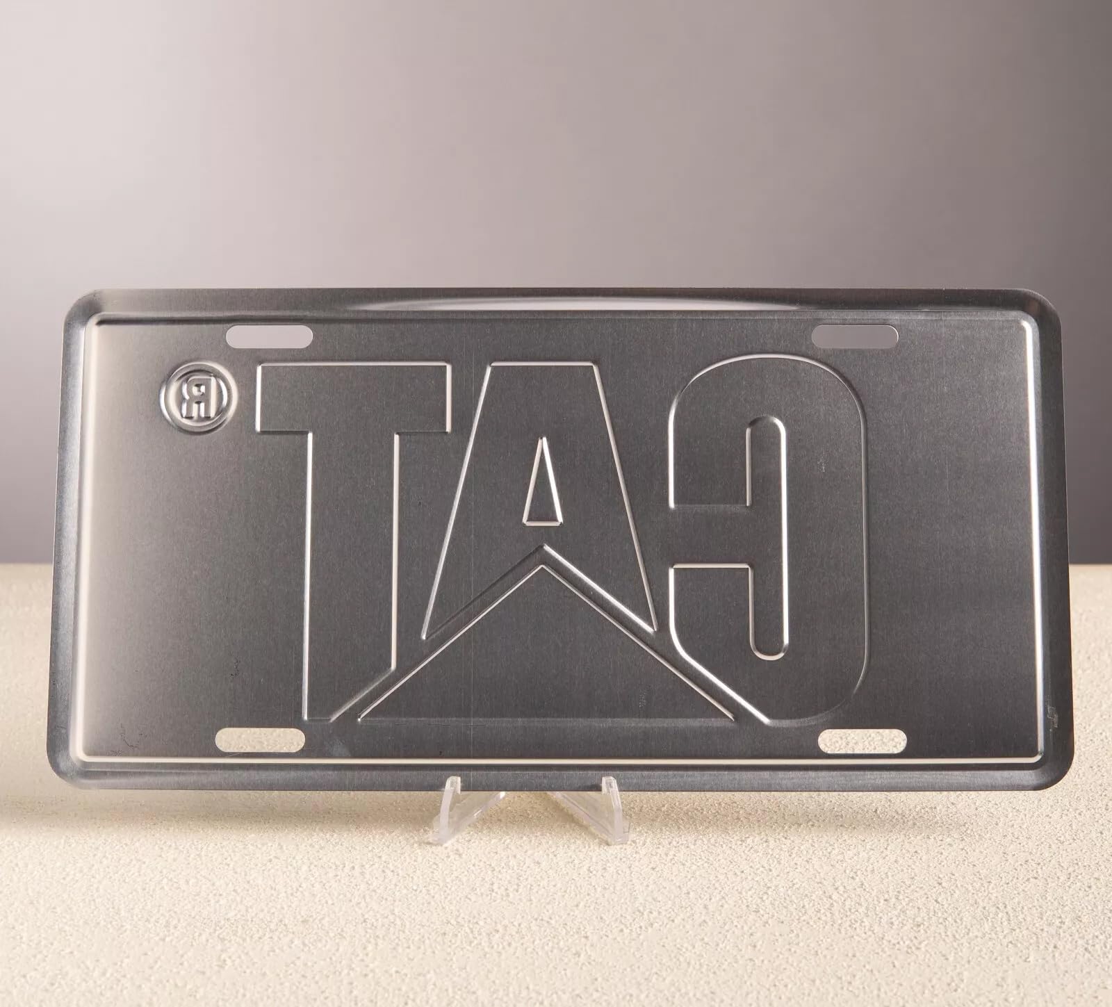 Embossed aluminum license plate featuring the cat logo on a black background for enduring style