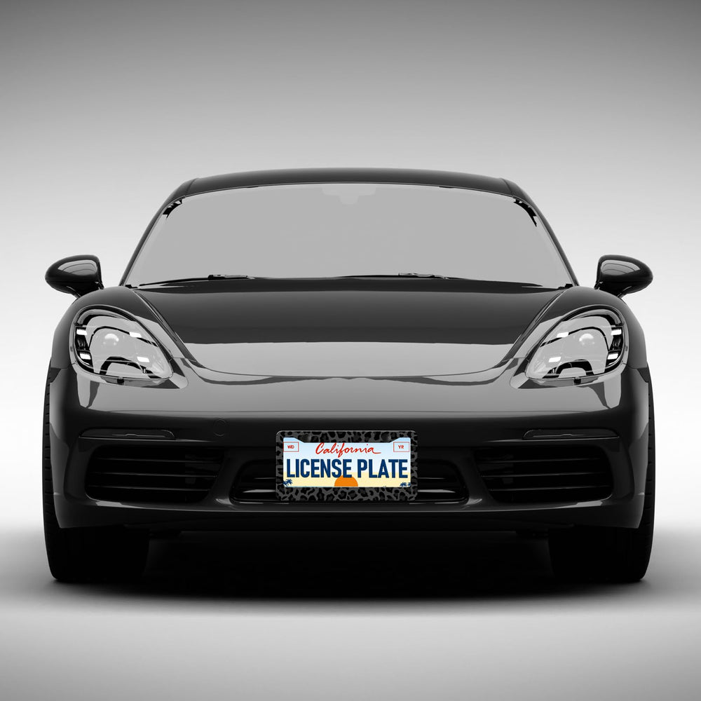 Leopard-print license plate frame installed on a car for standout appeal.