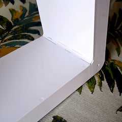 White finish garnish enhances RV interior around roof vent.