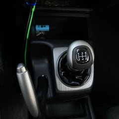 Close-up of GoaMotors leather boot on gear shift knob, premium feel.