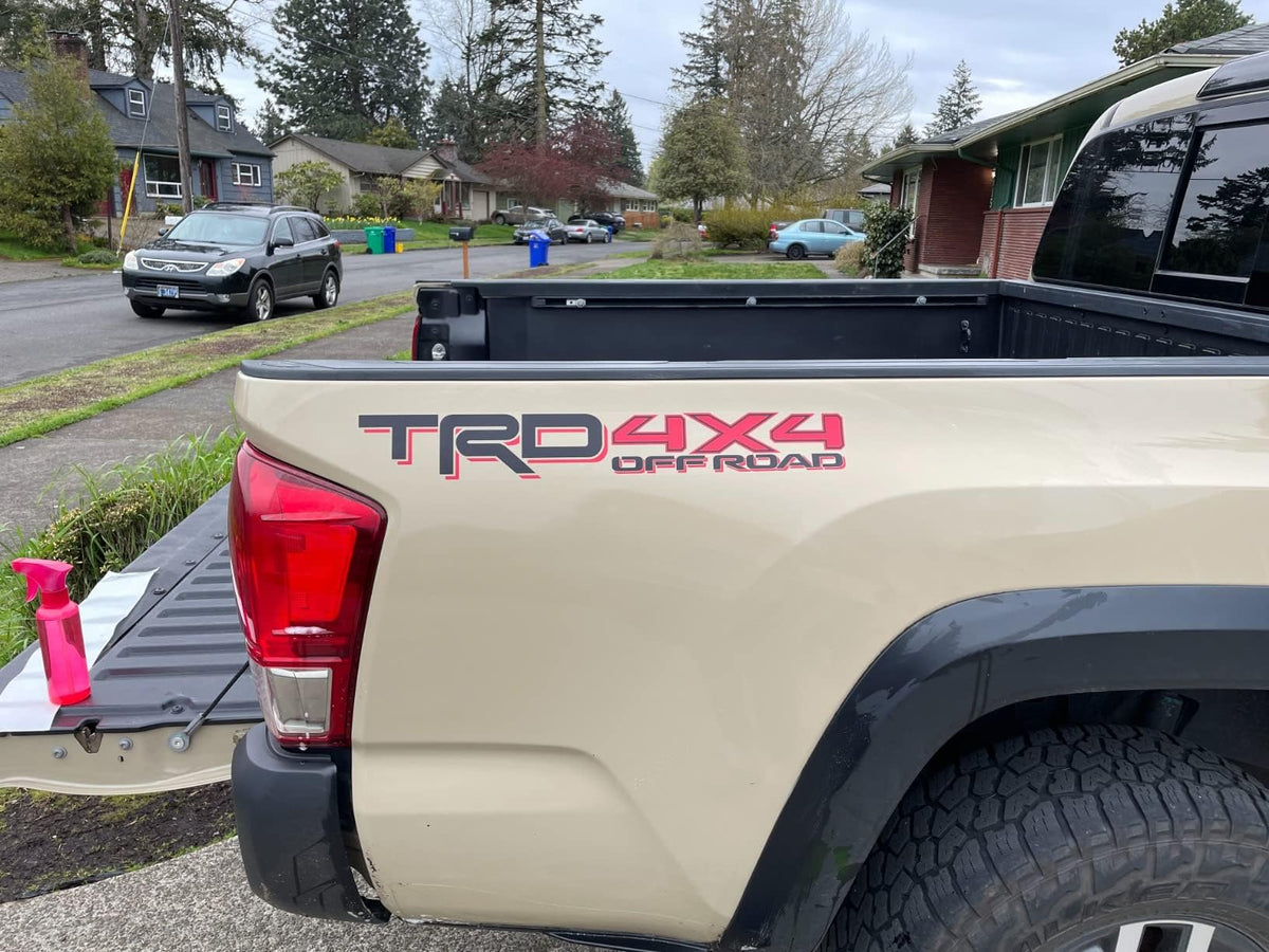 GO-GO.GROUP bedside decal set on clear vinyl with matte black and red 4x4 graphics.