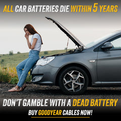 Goodyear jumper cables connected to dead battery during on-road emergency boost.