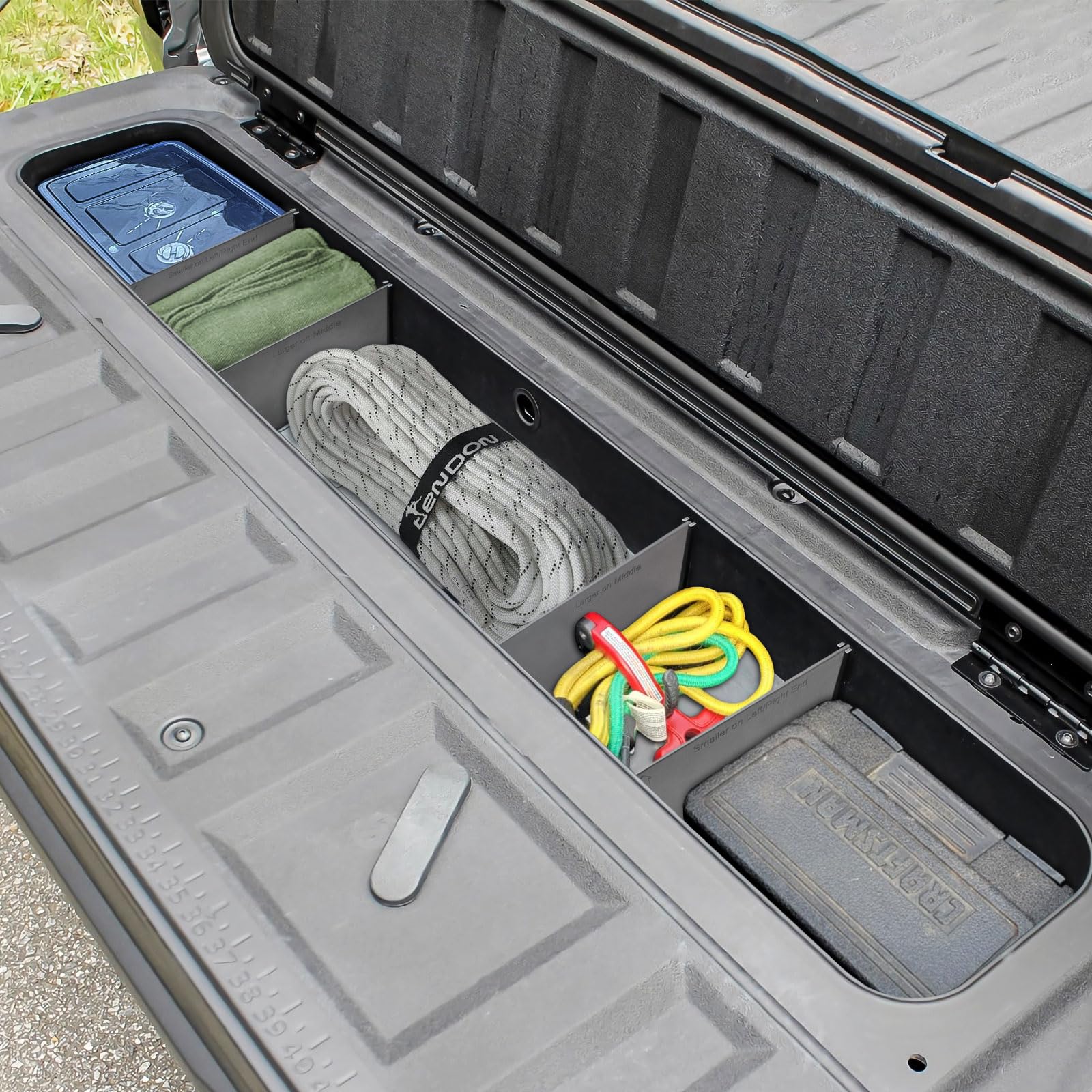 HGWEI tailgate storage tray demonstrates organized gear for work or weekend trips.