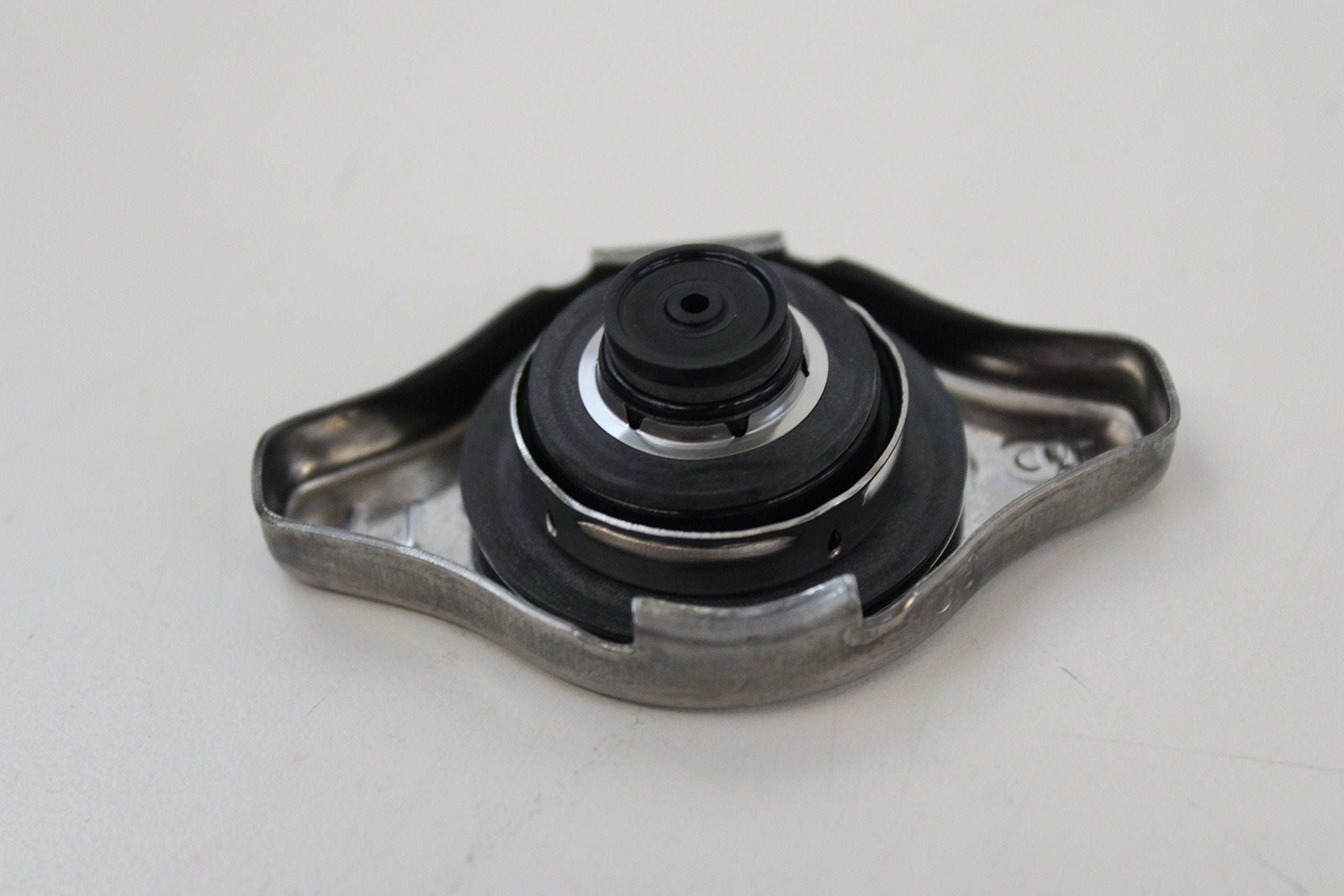 Close-up of Honda radiator cap top showing precision fit for reliable performance.