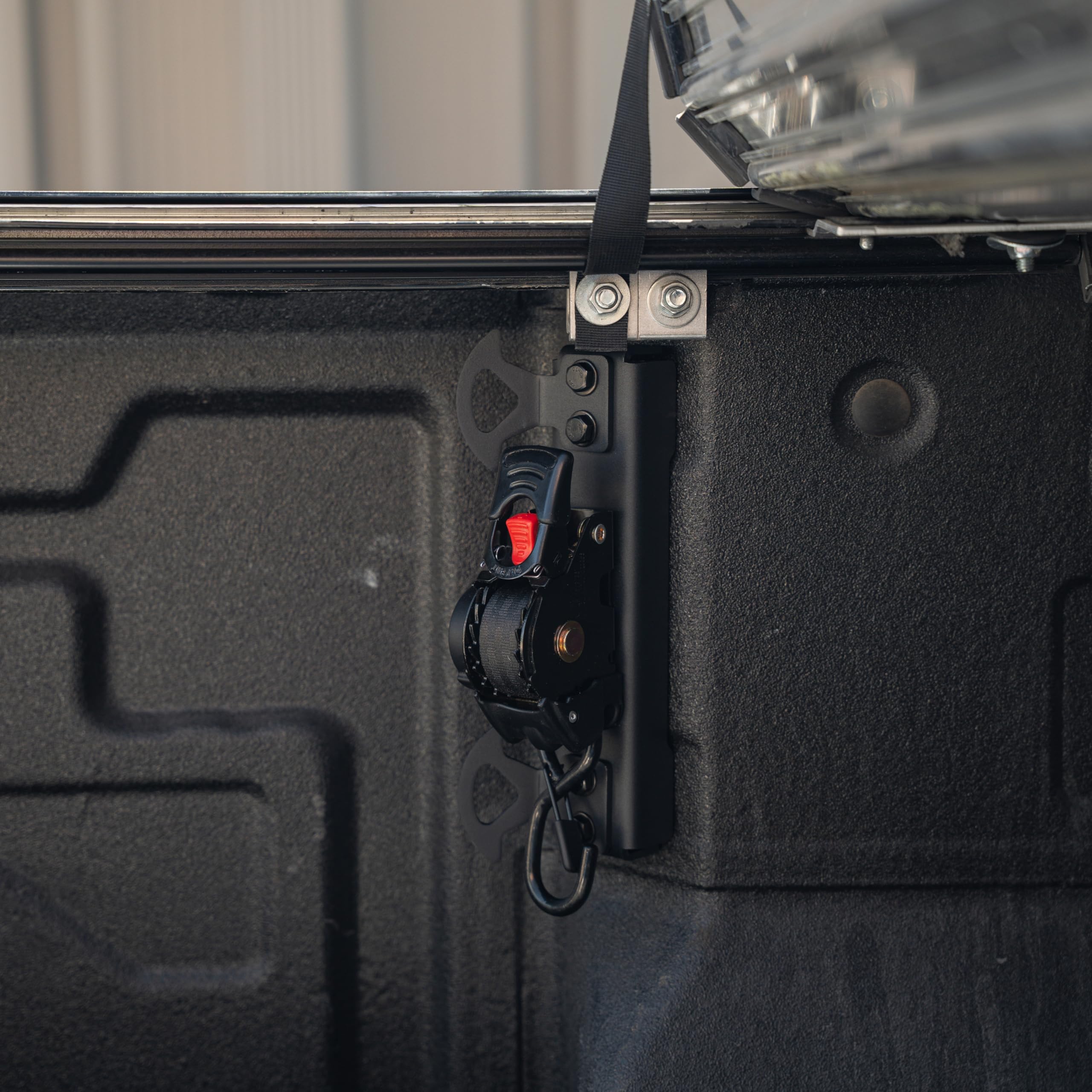 Integral Straps retractable strap extended for quick securement in the bed.