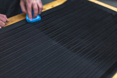 KOCHCHEMIE Gummifix spray application shown on rubber surface for easy cleaning.