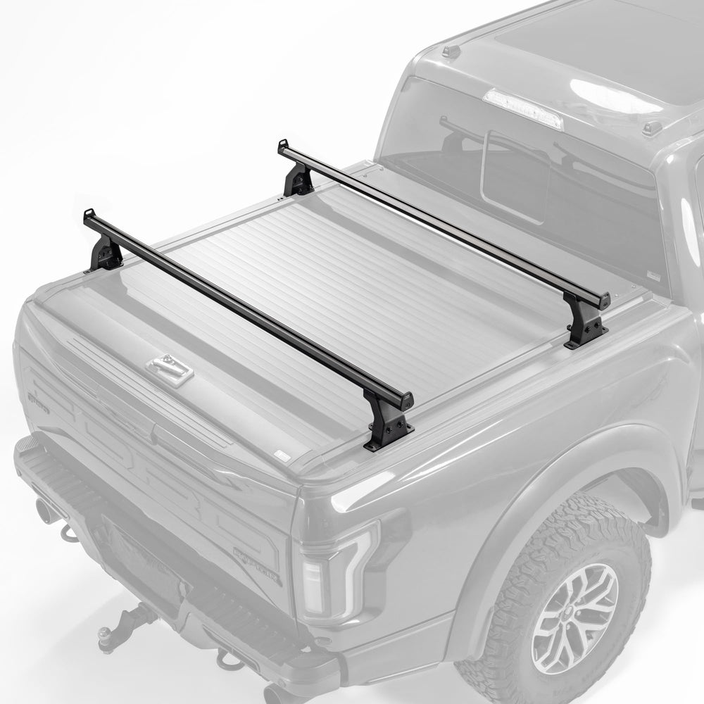KOKSHELY 65-4 inch cross bars installed on a mid-size truck for versatile hauling.