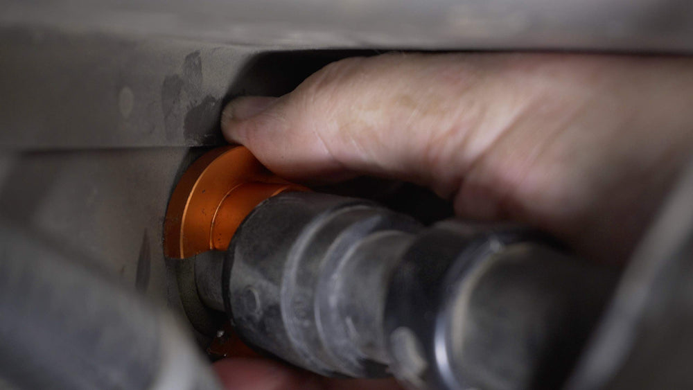 Lisle 39190 tool shown slipping over heater hose in tight space.