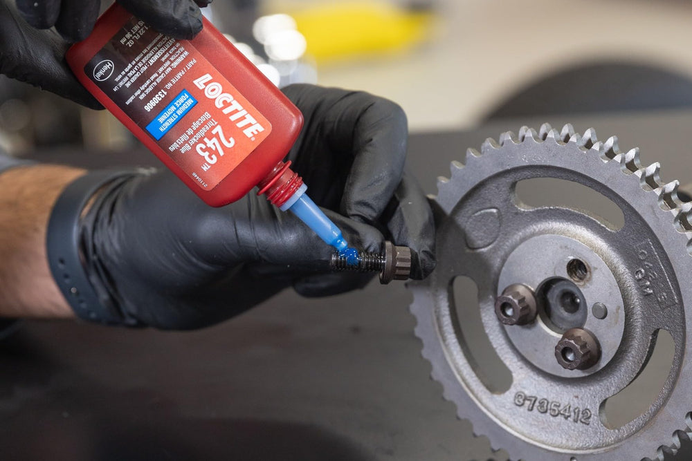Disc brake caliper bolt treated with Loctite 243 for vibration resistance.