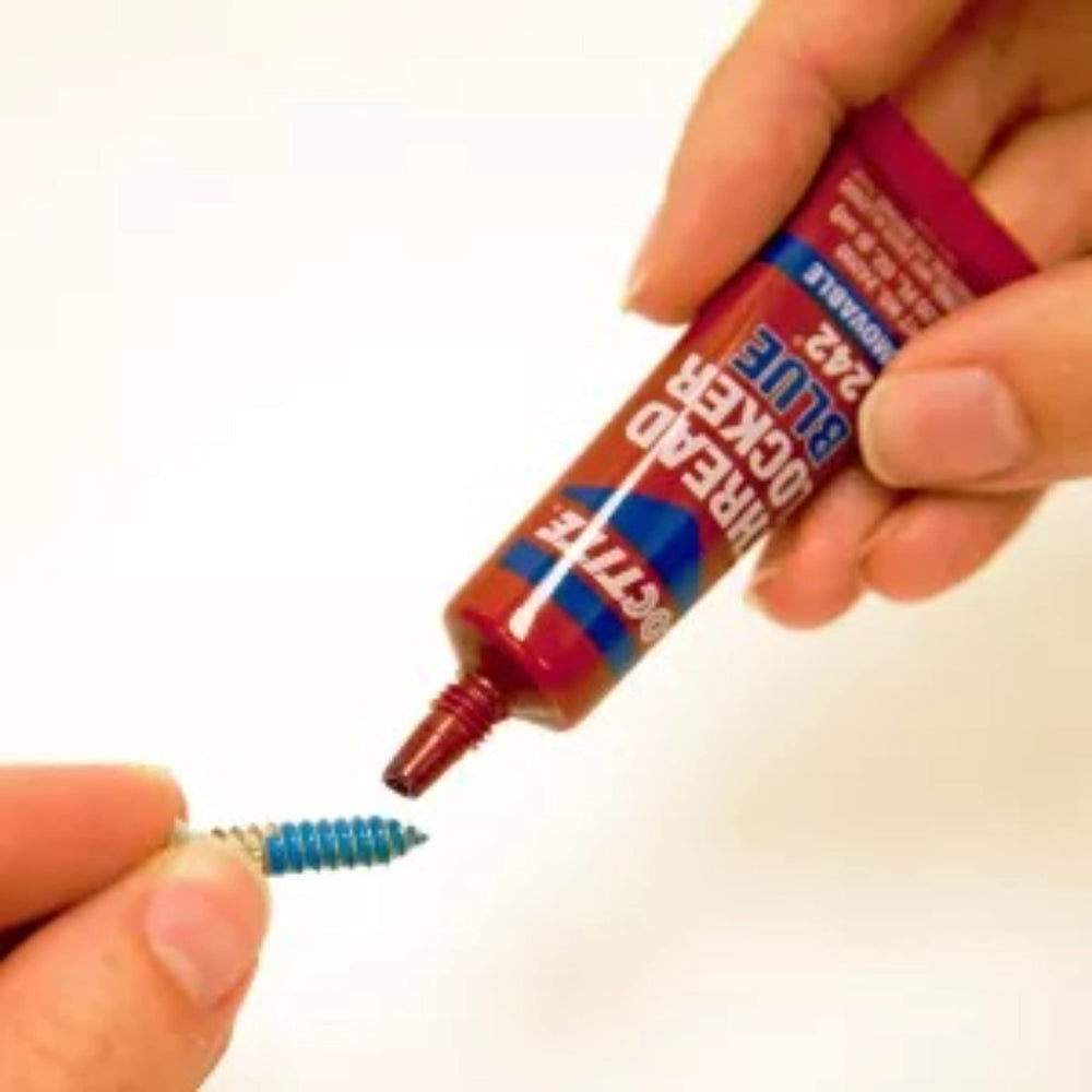 Loctite Blue 242 being dispensed onto threads with controlled application.