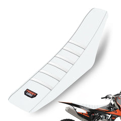 MCHMFG universal ribbed seat cover in all white provides strong grip for muddy dirt-bike rides.