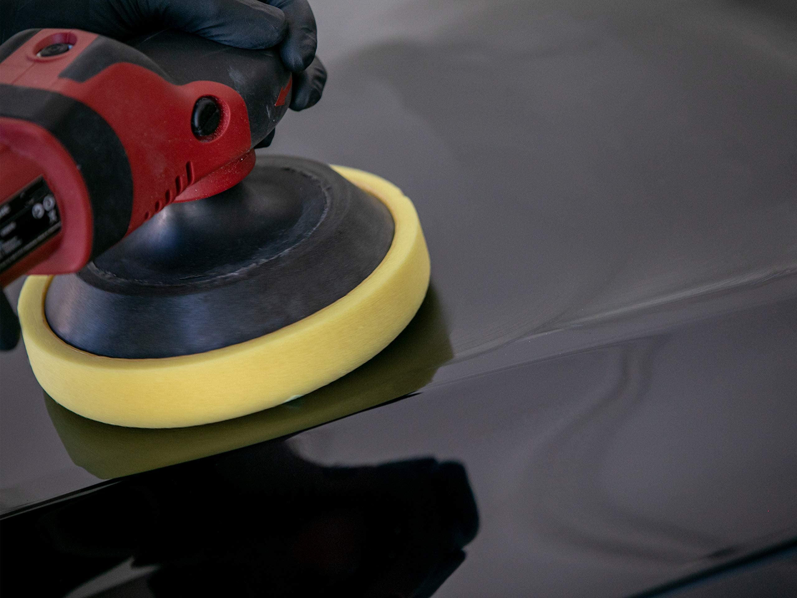 Professional detailing setup using Meguiar's cleaner-wax for a reflective shine.