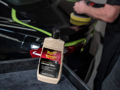 Close-up shows swirls being reduced with Meguiar's cleaner-wax for a clearer coat.