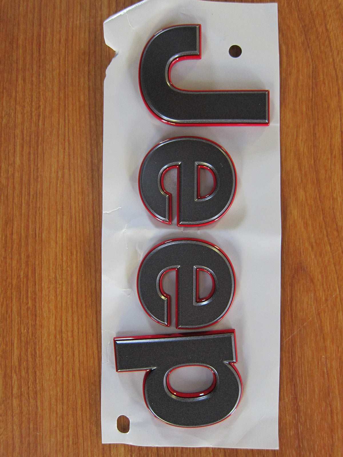 Mopar Jeep Wrangler JL gray badge front view showing authentic OEM styling