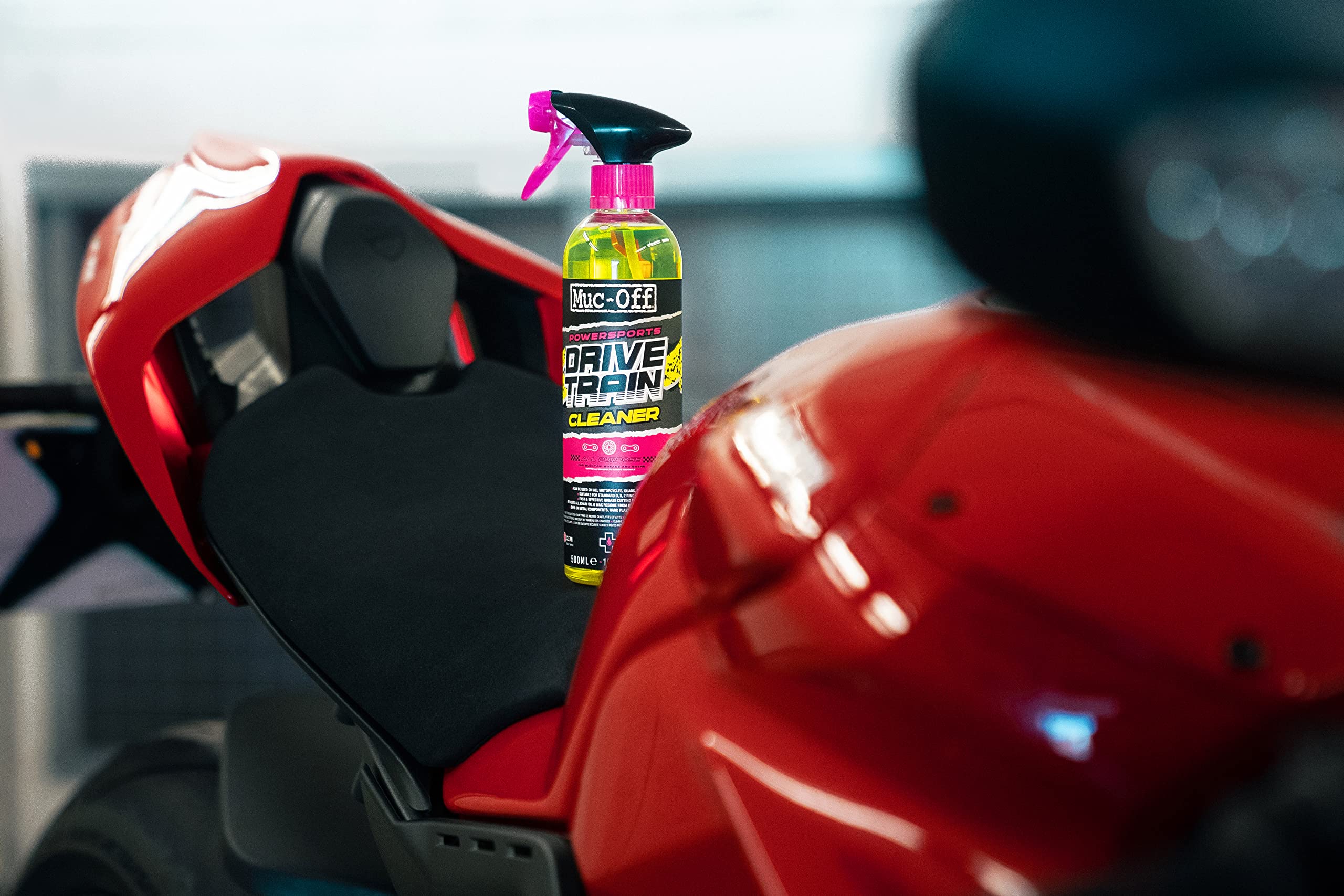 Muc-Off Powersports Drivetrain Cleaner sprayed on chain for rapid grime removal